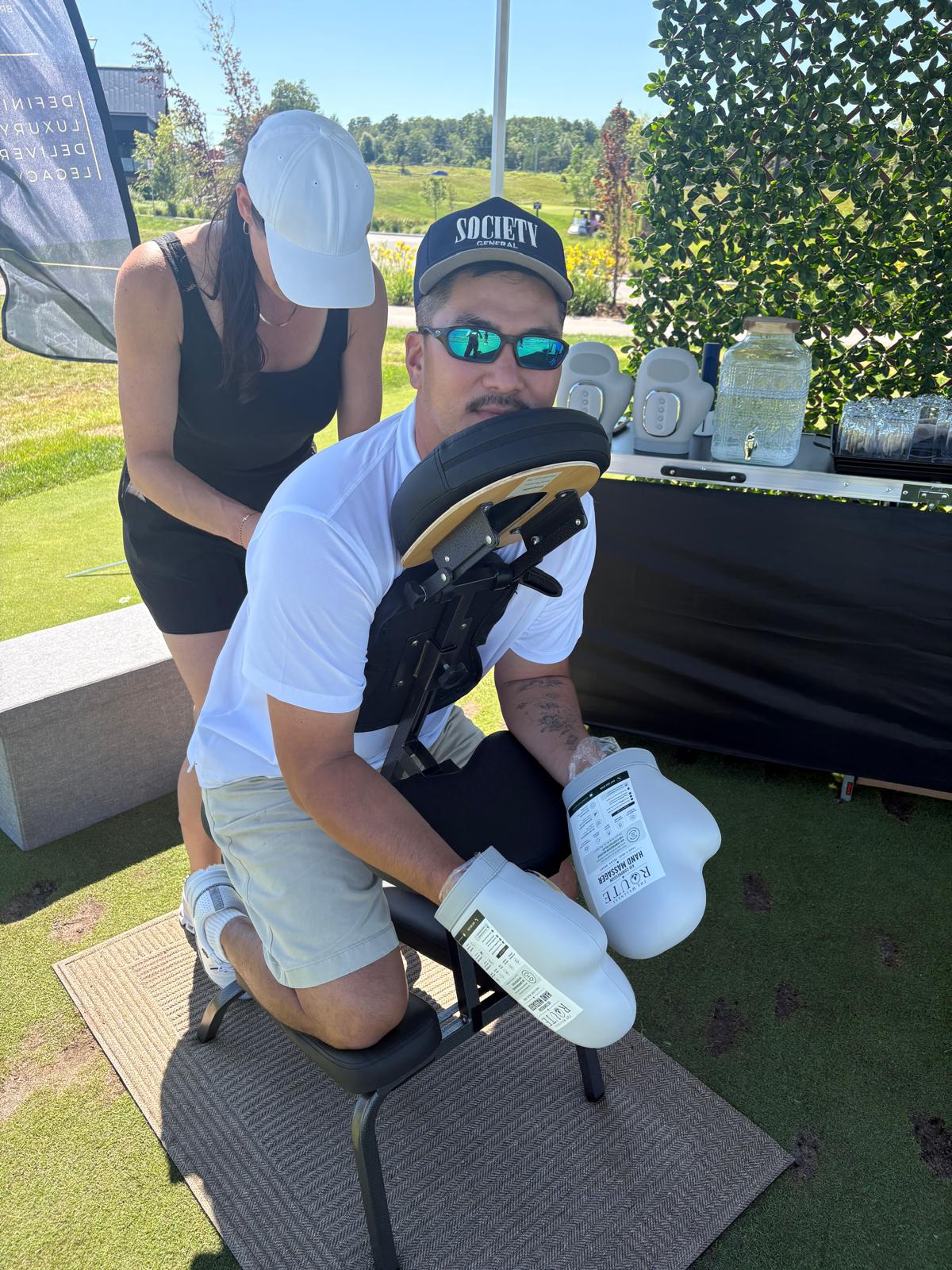 A guest using The Wellness Route recovery tools at a golf event.