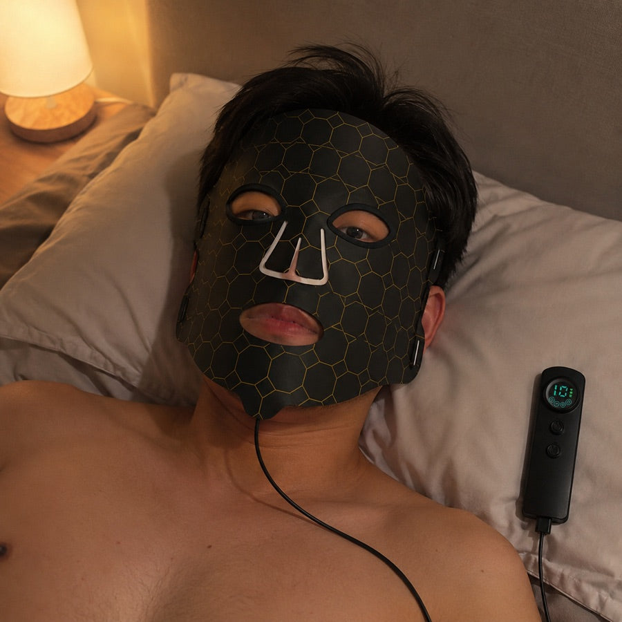 Man winding down in bed with the LED FLEX Mask