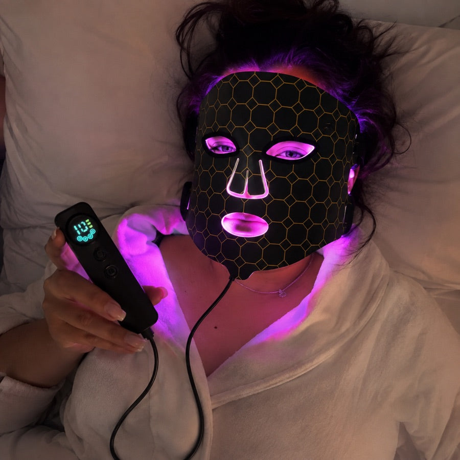 Woman relaxing with the LED FLEX Mask in purple light