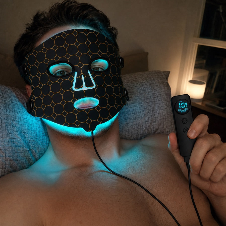 Man relaxing at home with the LED FLEX Mask and controller