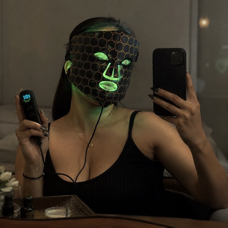 Woman capturing her green light LED FLEX Mask moment in the mirror